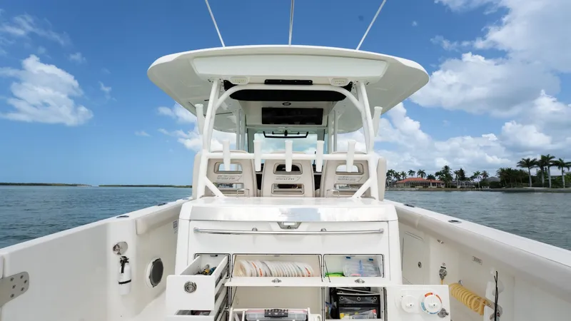  Yacht Photos Pics 2019 Boston Whaler 350 Outrage boat on water, featuring spacious deck and clear sky.