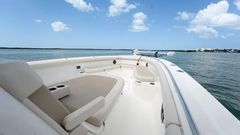  Yacht Photos Pics 2019 Boston Whaler 350 Outrage boat on calm water under a clear blue sky.
