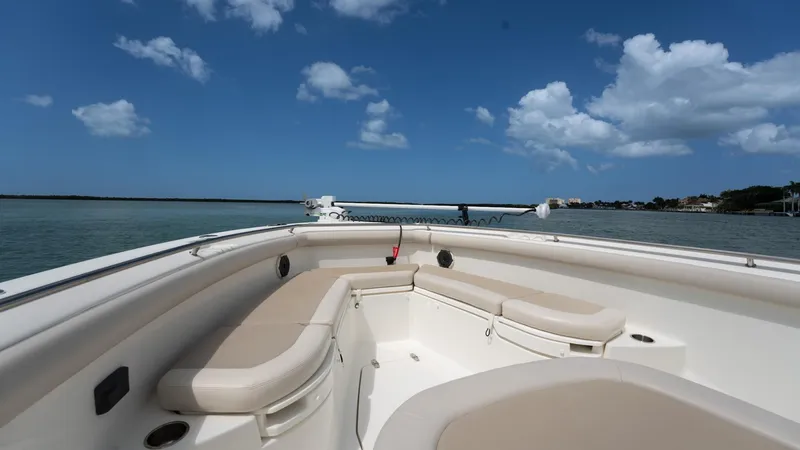 Yacht Photos Pics 2019 Boston Whaler 350 Outrage boat with spacious seating, cruising on calm waters under a blue sky.