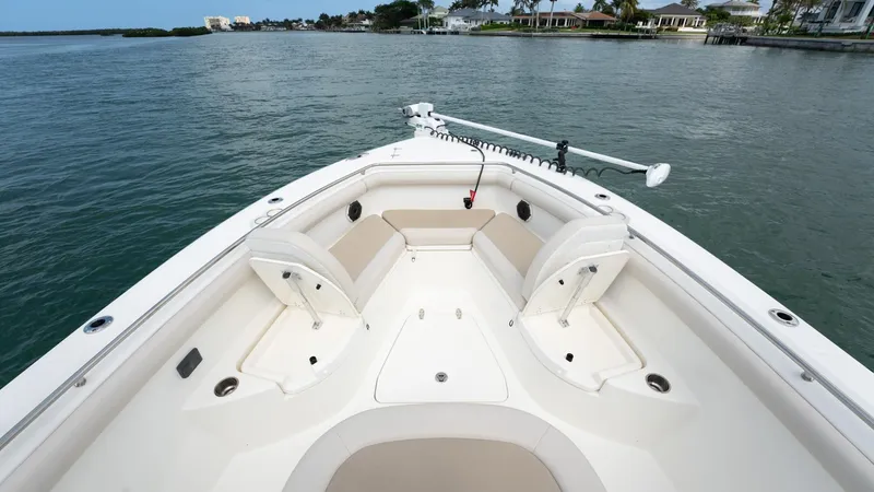  Yacht Photos Pics 2019 Boston Whaler 350 Outrage boat, spacious seating, calm waters, coastal background.