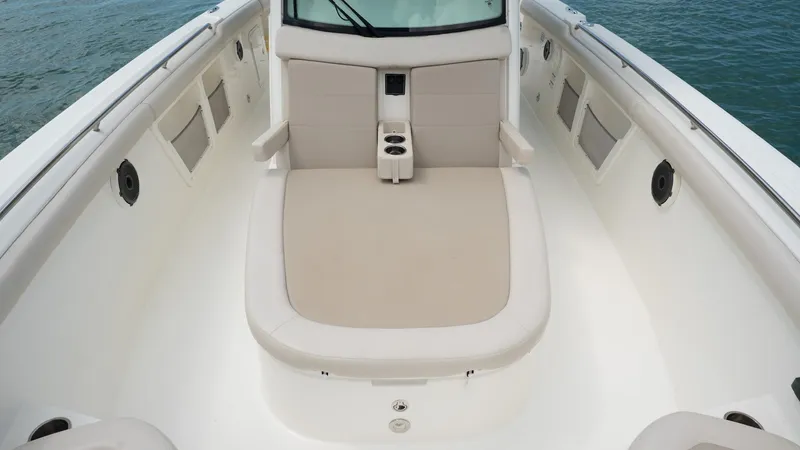 Yacht Photos Pics 2019 Boston Whaler 350 Outrage boat interior with cushioned seating and cup holders.