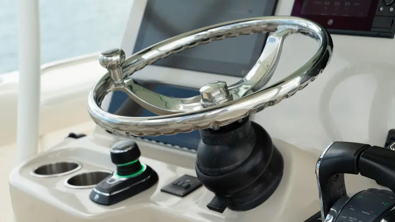  Yacht Photos Pics Steering wheel of 2019 Boston Whaler 350 Outrage boat, featuring modern controls.