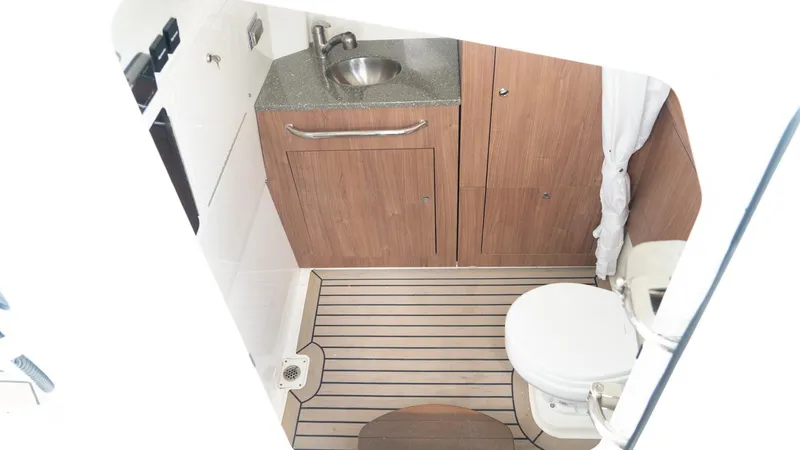  Yacht Photos Pics 2019 Boston Whaler 350 Outrage boat bathroom with wooden cabinetry and modern fixtures.