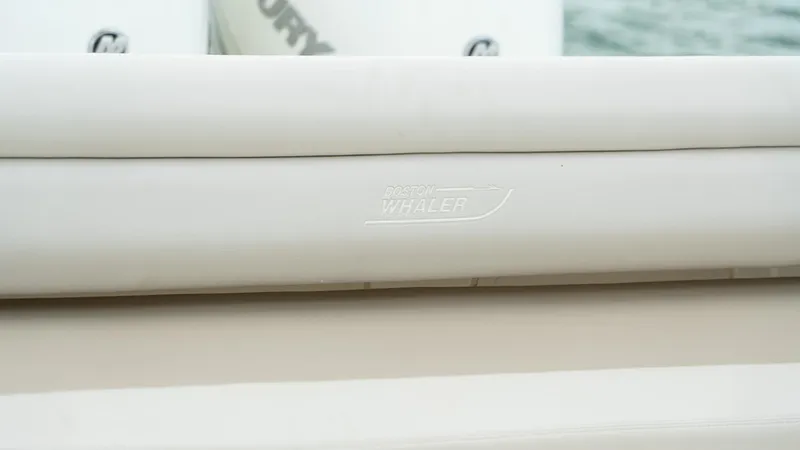  Yacht Photos Pics 2019 Boston Whaler 350 Outrage boat detail with logo, featuring sleek white design.