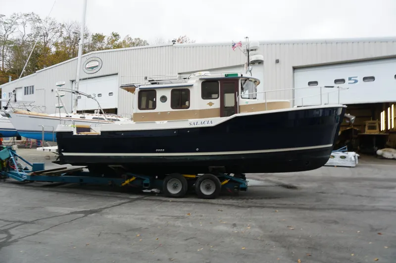  Yacht Photos Pics 2013 Ranger Tugs S-31 boat on trailer outside a large garage.