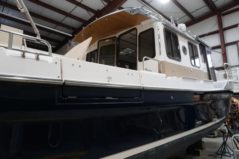  Yacht Photos Pics 2013 Ranger Tugs S-31 boat in a warehouse, showcasing its sleek design and structure.