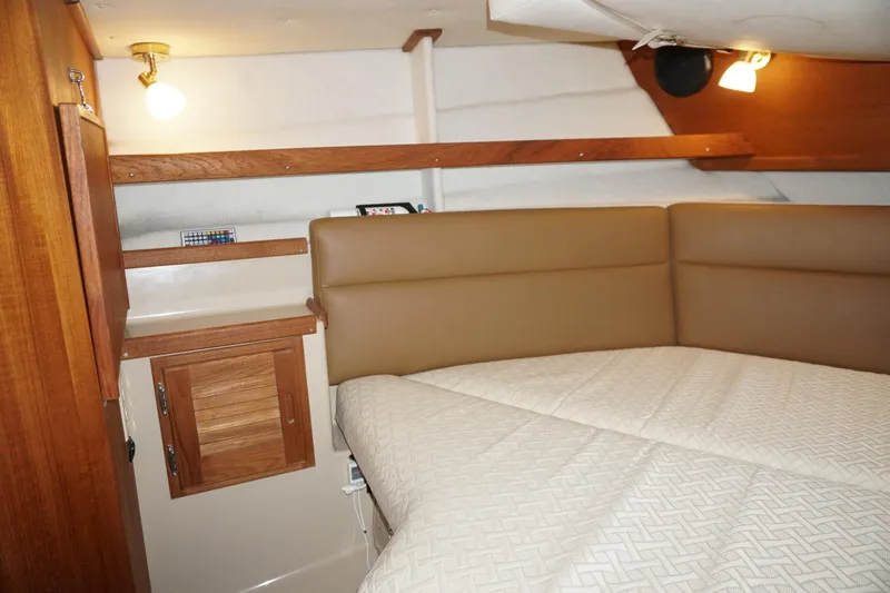  Yacht Photos Pics 2013 Ranger Tugs S-31 cabin interior with cozy bed and wooden accents.