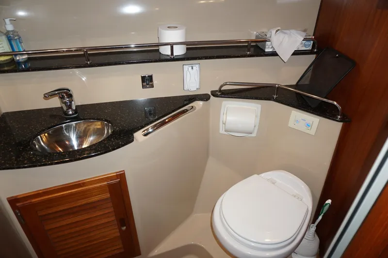  Yacht Photos Pics 2013 Ranger Tugs S-31 bathroom with sink, toilet, and storage cabinet.