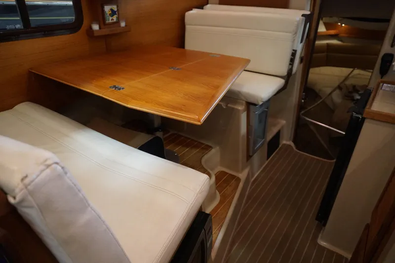  Yacht Photos Pics 2013 Ranger Tugs S-31 interior with wooden table and cushioned seating.