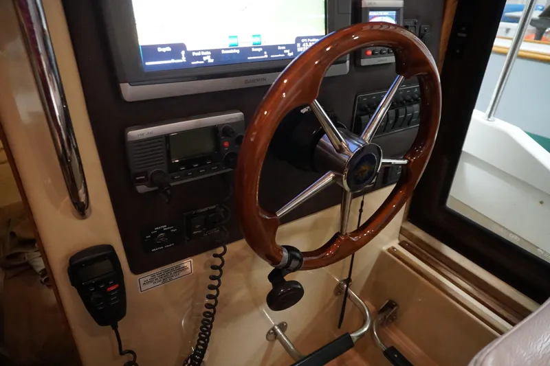  Yacht Photos Pics 2013 Ranger Tugs S-31 helm with wooden steering wheel and navigation equipment.