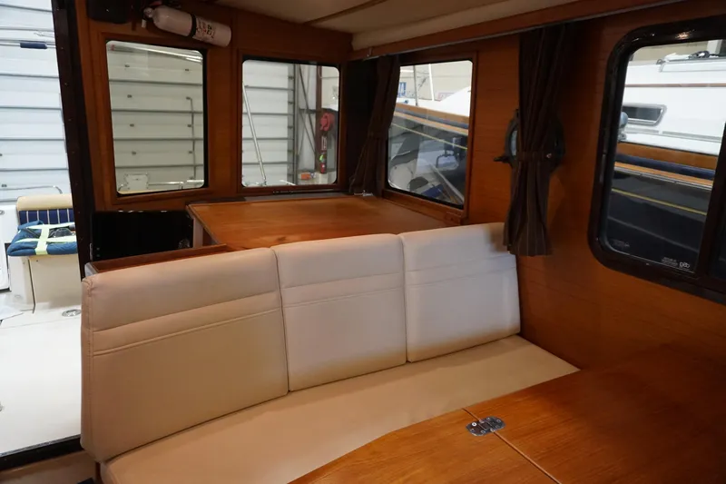  Yacht Photos Pics Interior of 2013 Ranger Tugs S-31 with beige seating and wooden accents.