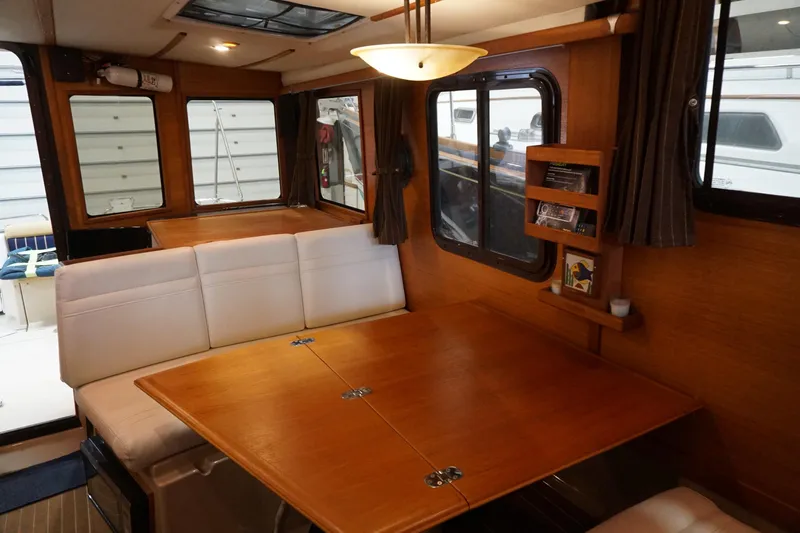  Yacht Photos Pics Interior of 2013 Ranger Tugs S-31 with wooden table and white seating.