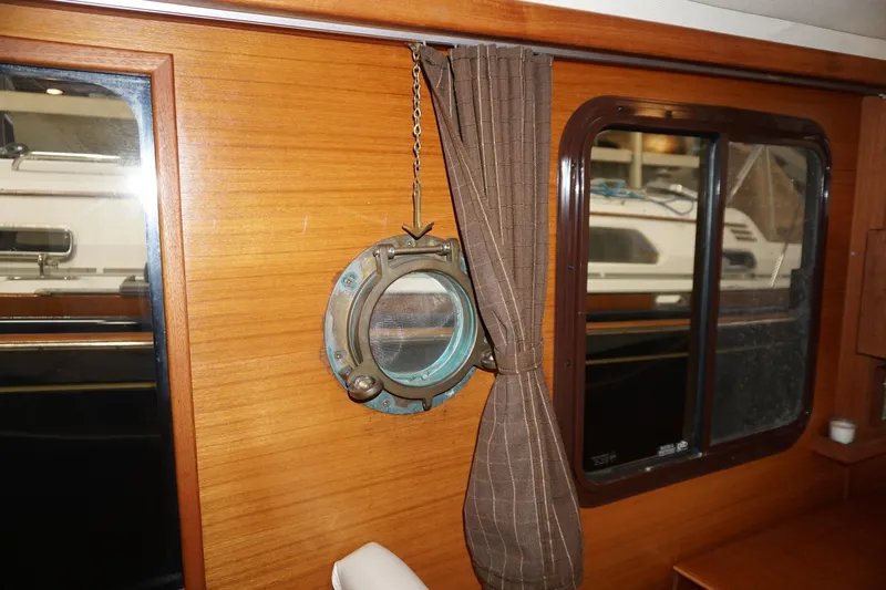  Yacht Photos Pics Interior of 2013 Ranger Tugs S-31 with wooden paneling and nautical decor.