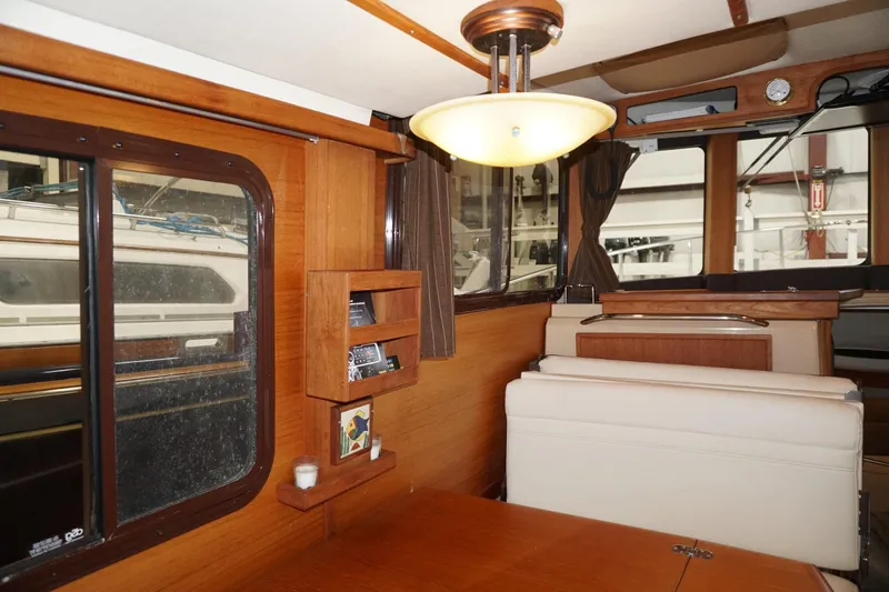  Yacht Photos Pics Interior of 2013 Ranger Tugs S-31 boat with wood paneling and seating area.