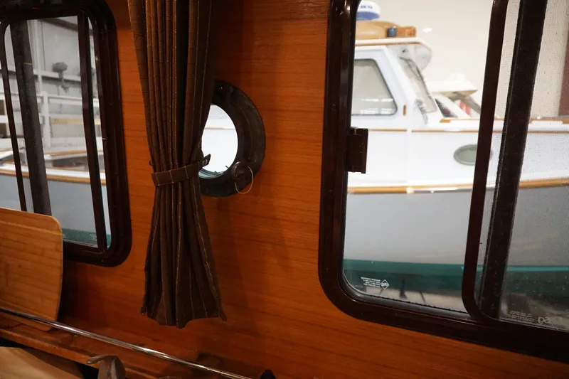  Yacht Photos Pics Interior view of 2013 Ranger Tugs S-31, showcasing wooden paneling and window.