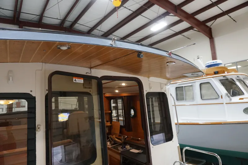  Yacht Photos Pics 2013 Ranger Tugs S-31 boat interior with wooden ceiling in a storage facility.