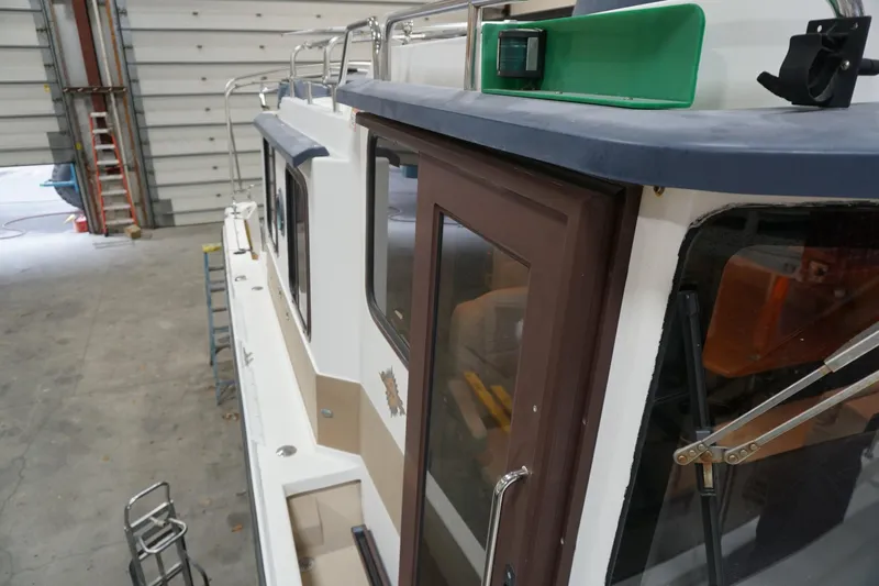  Yacht Photos Pics 2013 Ranger Tugs S-31 boat in a garage, side view with green navigation light.