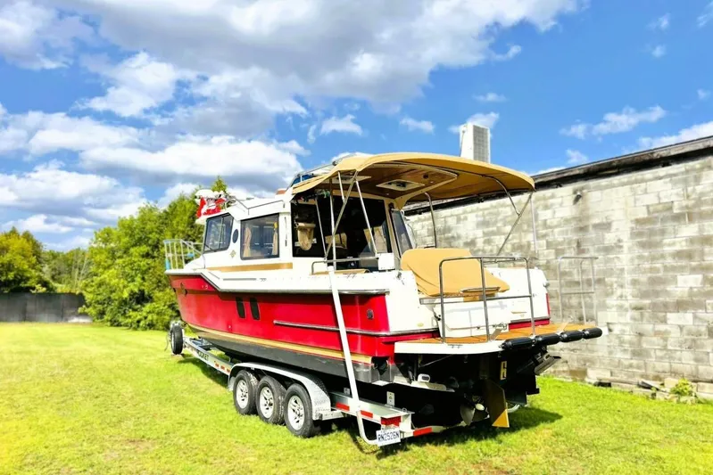  Yacht Photos Pics 2017 Ranger Tugs R-29S boat on trailer, parked on grass under a blue sky.