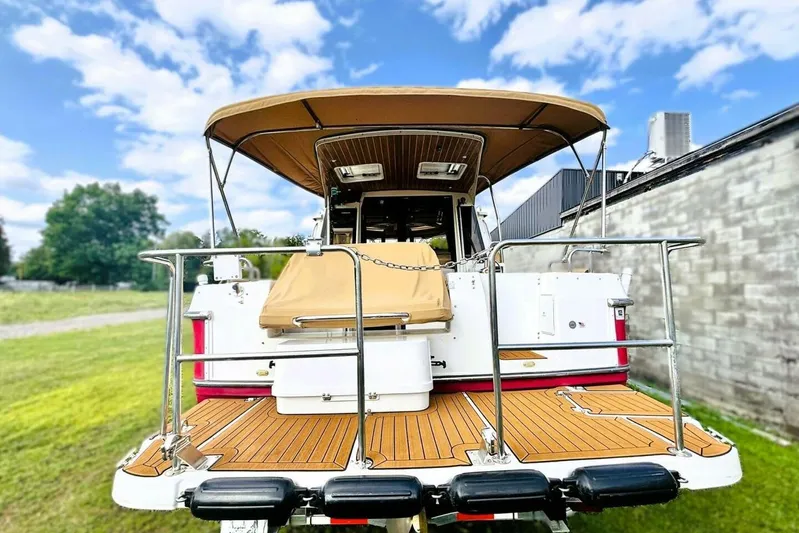  Yacht Photos Pics 2017 Ranger Tugs R-29S boat with canopy, docked outdoors under a blue sky.