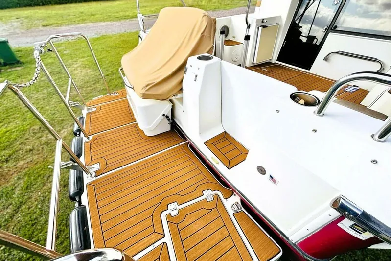  Yacht Photos Pics 2017 Ranger Tugs R-29S boat deck with teak flooring and covered seating area.