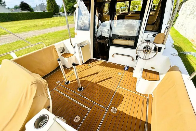  Yacht Photos Pics 2017 Ranger Tugs R-29S boat interior with teak flooring and beige seating.
