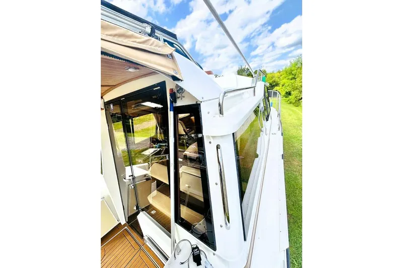 Yacht Photos Pics 2017 Ranger Tugs R-29S boat exterior with glass doors and scenic background.
