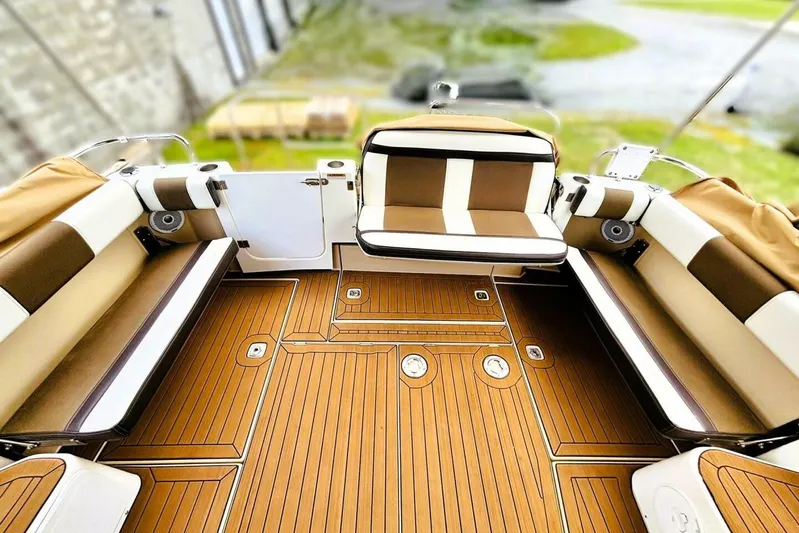  Yacht Photos Pics 2017 Ranger Tugs R-29S boat interior with teak flooring and cushioned seating.