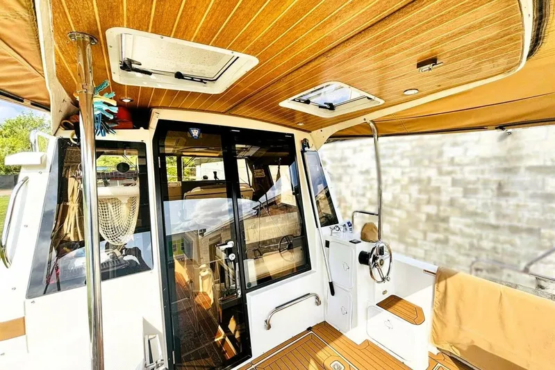  Yacht Photos Pics 2017 Ranger Tugs R-29S interior with wood accents and steering wheel.