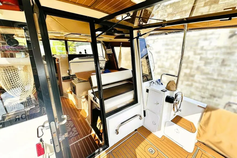  Yacht Photos Pics Interior view of 2017 Ranger Tugs R-29S boat, featuring seating and helm station.