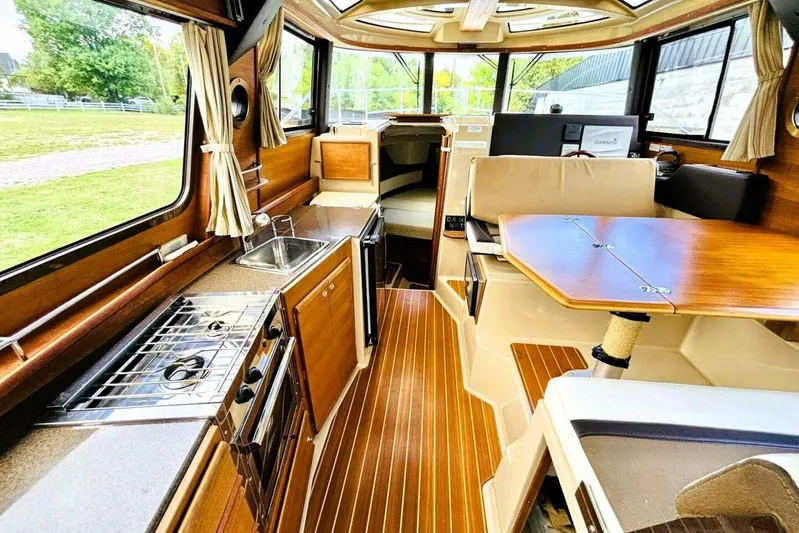  Yacht Photos Pics Interior of 2017 Ranger Tugs R-29S with kitchen, dining area, and wood finishes.