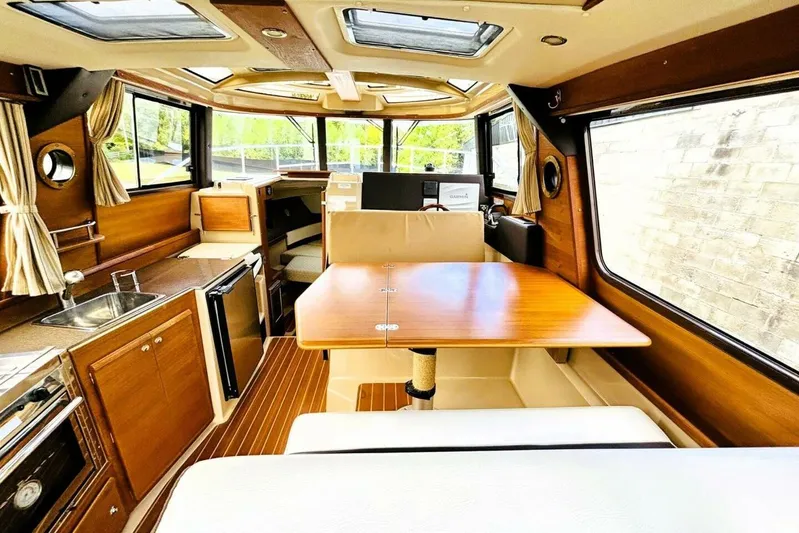  Yacht Photos Pics Interior of 2017 Ranger Tugs R-29S boat with wood finishes and dining area.