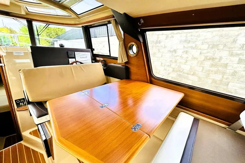  Yacht Photos Pics Interior of 2017 Ranger Tugs R-29S with wooden table and seating area.