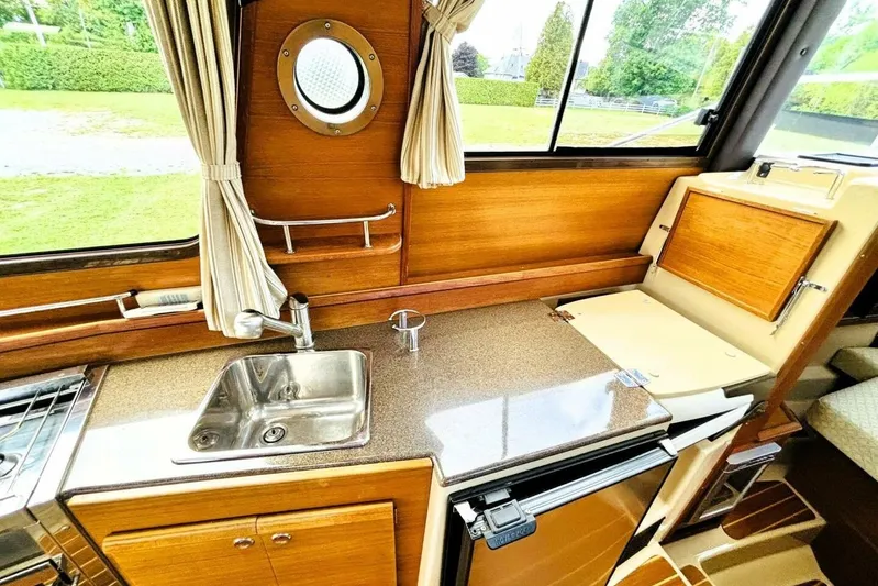  Yacht Photos Pics 2017 Ranger Tugs R-29S interior kitchen with sink, countertop, and window view.