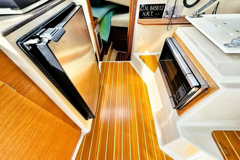  Yacht Photos Pics 2017 Ranger Tugs R-29S interior with wood flooring, fridge, and microwave.