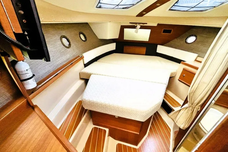  Yacht Photos Pics 2017 Ranger Tugs R-29S cabin interior with cozy bed and wooden accents.
