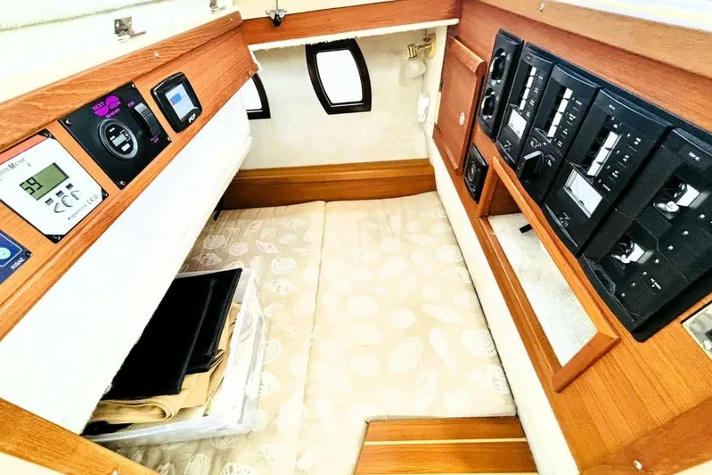  Yacht Photos Pics 2017 Ranger Tugs R-29S cabin interior with control panels and cozy sleeping area.