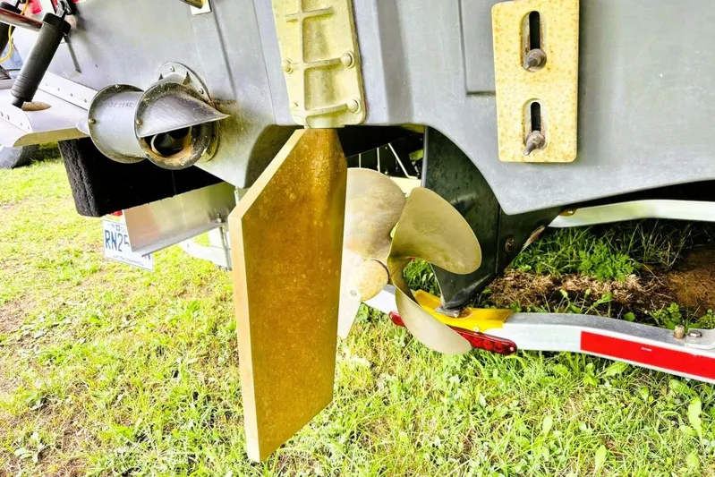  Yacht Photos Pics 2017 Ranger Tugs R-29S boat propeller and rudder on trailer, grassy background.