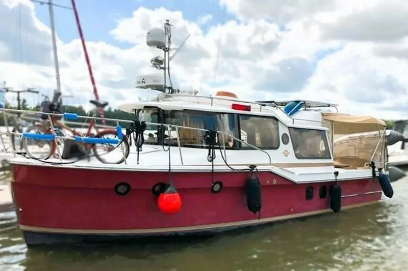  Yacht Photos Pics 2017 Ranger Tugs R-29S boat docked, featuring a red hull and modern equipment.