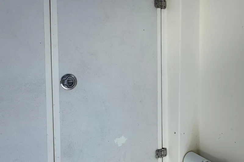  Yacht Photos Pics 2021 Marlin 39 CC boat interior with white panel and metal latch.