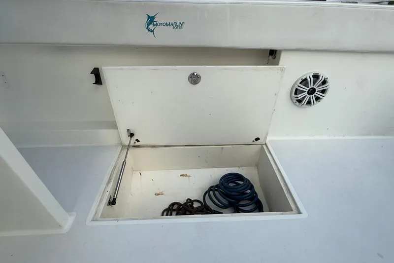  Yacht Photos Pics Open storage compartment on 2021 Marlin 39 CC boat with coiled hose and speaker.