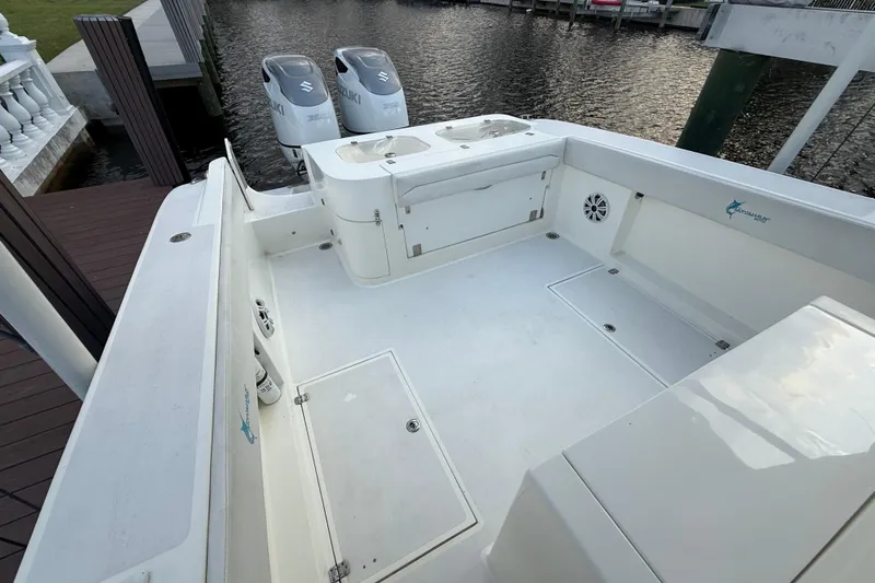  Yacht Photos Pics 2021 Marlin 39 CC boat deck with Suzuki engines, docked by the water.