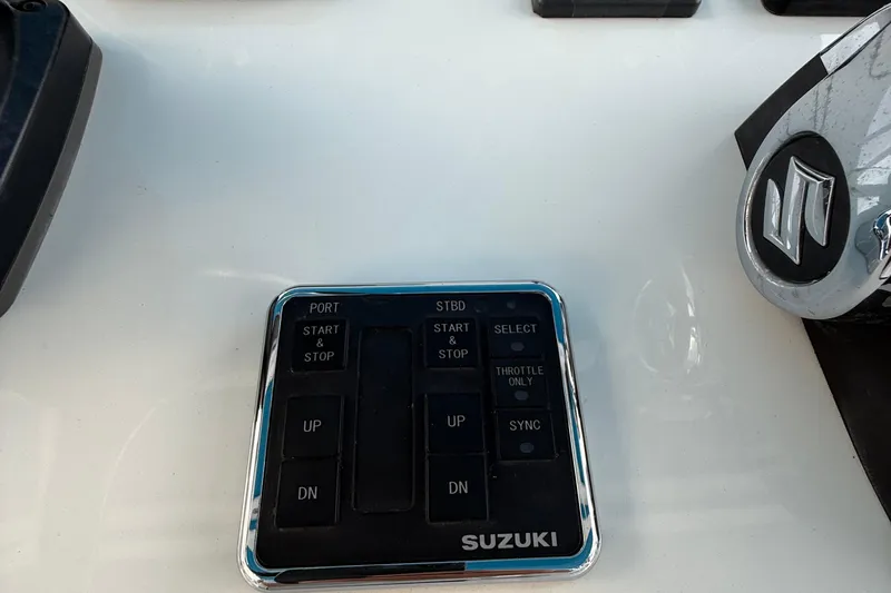  Yacht Photos Pics Control panel of a 2021 Marlin 39 CC boat with Suzuki branding.