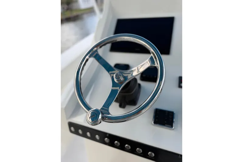  Yacht Photos Pics Steering wheel of 2021 Marlin 39 CC boat, featuring sleek chrome design.