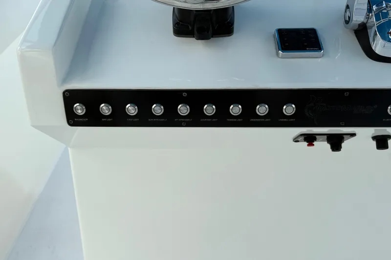  Yacht Photos Pics Control panel of a 2021 Marlin 39 CC boat with labeled buttons and switches.