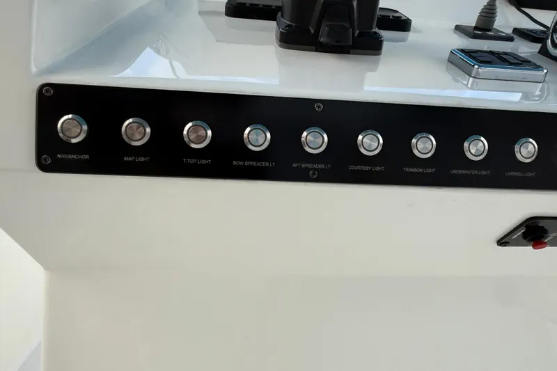  Yacht Photos Pics Control panel of a 2021 Marlin 39 CC boat with labeled light switches.