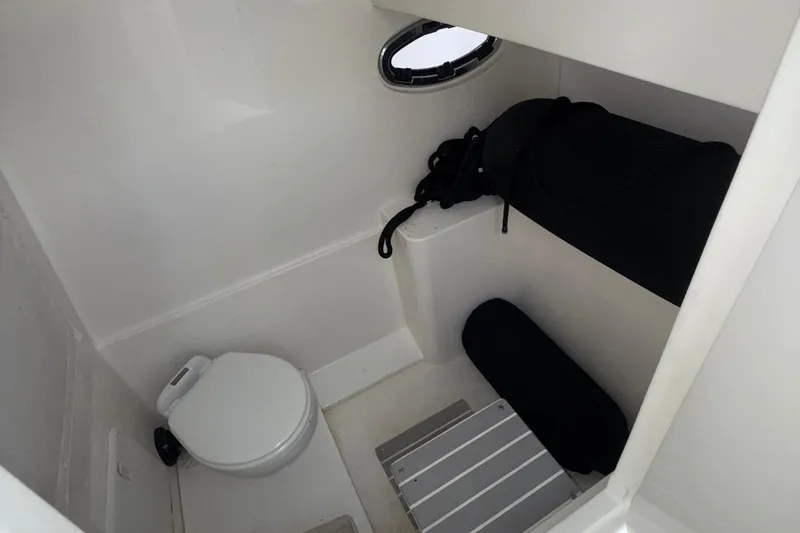  Yacht Photos Pics 2021 Marlin 39 CC boat interior with compact toilet and storage area.