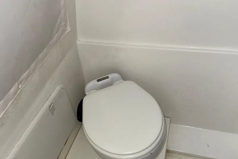  Yacht Photos Pics 2021 Marlin 39 CC boat bathroom with compact white toilet.