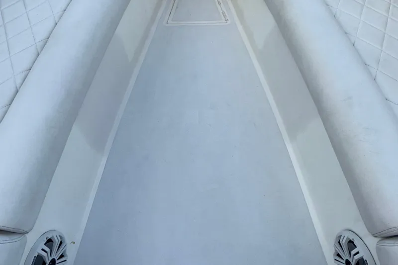  Yacht Photos Pics 2021 Marlin 39 CC boat interior with white cushioned seating and speakers.