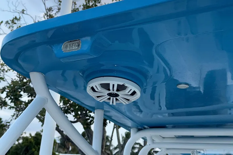  Yacht Photos Pics 2021 Marlin 39 CC boat with blue canopy and mounted speaker.