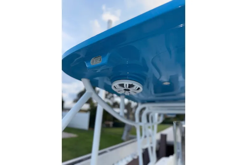  Yacht Photos Pics 2021 Marlin 39 CC boat with blue canopy and speaker detail.